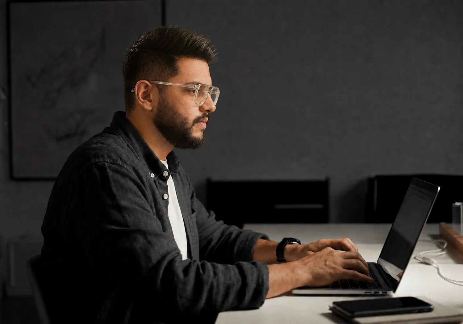Faiz Ahmed working on a laptop